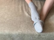 The girl her legs and takes off her socks with her feet 11/16