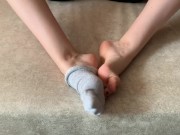 The girl her legs and takes off her socks with her feet 16/16