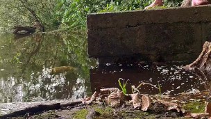 Stripping down naked inside a forest stroking my big skinny Cock at a lake and dipping my feet in