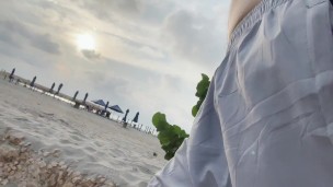 Walking with no shirt and no underwear on the beach