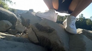 Risky public masturbation, cumshot outside, outdoors, by the water, of a twink with long black hair