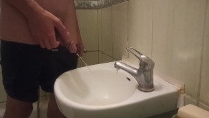 pissing my beautiful circumcised cock in the sink