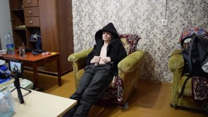 a guy in a black jacket on a chair jerks off his dick and cums a lot of sperm