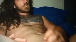 Long hair and tats strokes cock until he cums