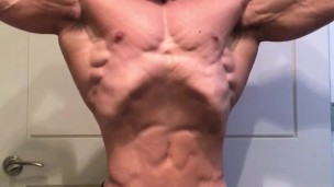 Jacked bodybuilder Benji Bastian flexing his huge, shredded, muscles