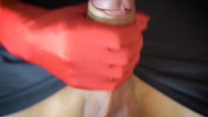 Russian guy masturbates cock with red gloves close up