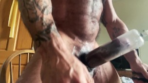 Muscle Daddy uses his nipple suckers and dick pump.