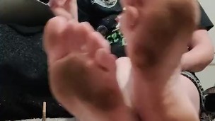 Hot blonde chilling on the floor showing off her dirty stained soles while she smokes a cigarette