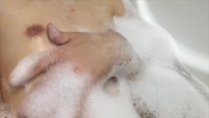 A skinny boy caresses himself in the bath