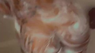 Rubbing my sexy femme down with soap in the shower