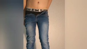 A guy shows what a chastity belt looks like under his clothes - a chastity cage in jeans