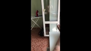 guy jerks off his big dick by the window