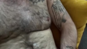 Hairy dad sits back and strokes on the couch, grunting, teasing and edging out a big load