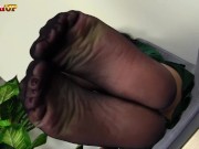 Mistress Alexya wears black sheer stockings and puts feet in your face 10/16