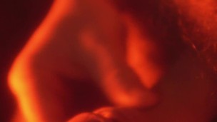 A man touches himself gently