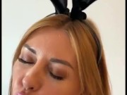 Hot MILF in a bunny costume gives blowjob to a huge dildo
