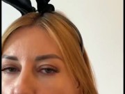 Hot MILF in a bunny costume gives blowjob to a huge dildo 9/16