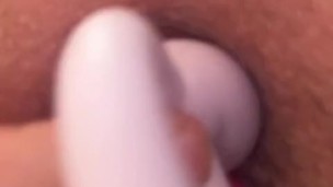 Amateur playing with 2 anal plugs, inserting both at same time in ass.