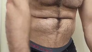 HAIRY MUSCLE BEAR FLEXING IN BLACK BOXER BRIEFS