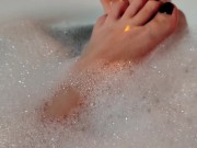 Hot blonde massaging her wet soapy feet in the bath 1/16