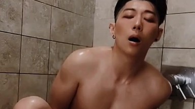 Horny Asian college jock plays with dildo in risky public shower