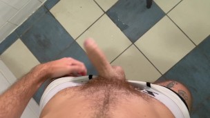 Solo bald man wanking and pissing in the toilet