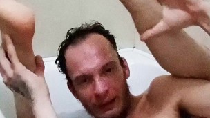 Legs behind the head in a bathtub while touching my cock and showing off feet soles