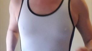 Work out in wrestling singlet, plays with his thick pierced cock and shoots his load