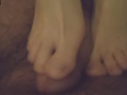 Skinny brunette gives a footjob in the bathroom 13/16