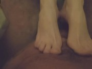 Skinny brunette gives a footjob in the bathroom 9/16