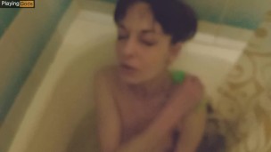 Skinny brunette gives a footjob in the bathroom