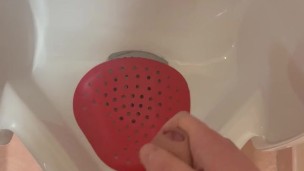 Jerking off into public urinal