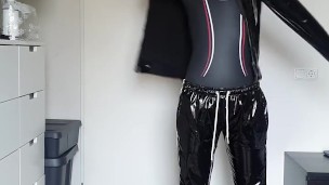 Boy putting on PVC over his wetsuit