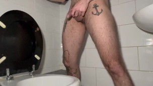 licking toilet seat in a public bathroom