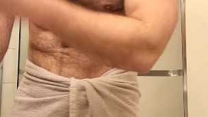 Hairy muscle bear flexing before shower