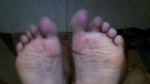 Muscle bear shows his big bear feet and wants them licked, sucked and worshipped