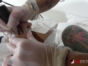 Busty babe rides a hard dick as she tattoos him! 9/16