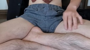 An office worker wearing a jacket, underpants and tie is masturbating