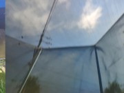 Tall girl in shorts jumping barefooted on a trampoline (slowed down) bottom view 14/16