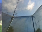 Tall girl in shorts jumping barefooted on a trampoline (slowed down) bottom view 15/16