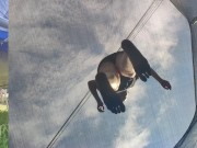 Tall girl in shorts jumping barefooted on a trampoline (slowed down) bottom view 3/16