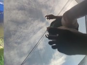 Tall girl in shorts jumping barefooted on a trampoline (slowed down) bottom view 9/16