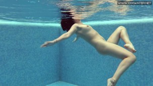 Cute petite teen wearing cute clothes underwater
