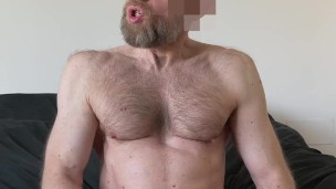 Hairy daddy jerks off on his black sheets and tastes his own precum