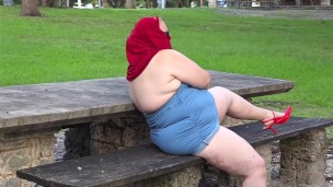 Pissing in public - busty milf in mini dress showing off big juicy ass and flashing pussy close up