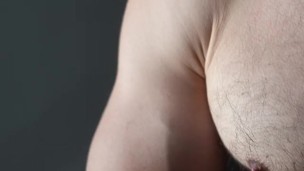 a handsome guy with blue eyes with a big dick jerks off in front of the window