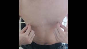 A perverted masochistic man masturbates by pulling his nipples