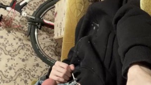 A guy in a jacket and a hat masturbates and cums upside down on his jacket