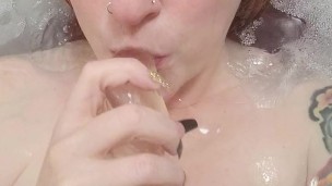 Gorgeous redhead with perfect tits teasing her toy in the bath