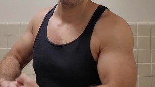 Hairy muscle bear flexing in black tank top